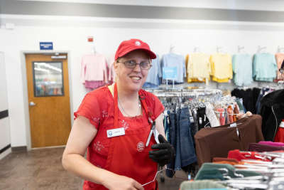 Deseret Industries lead sorts through women’s thrifted clothing