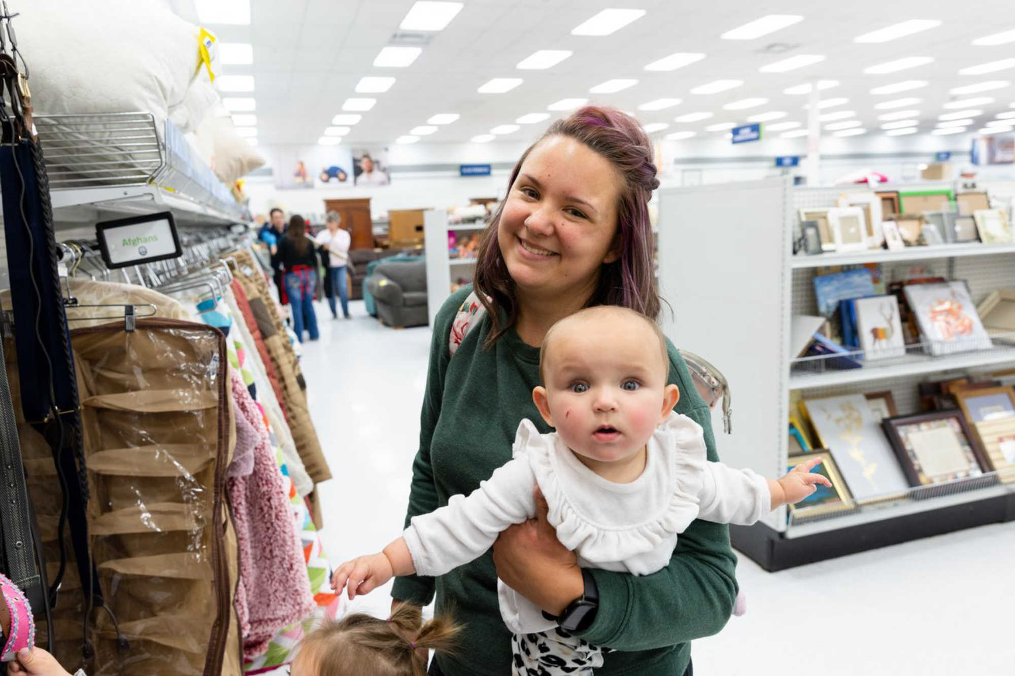 mom with baby shopping at deseret industries