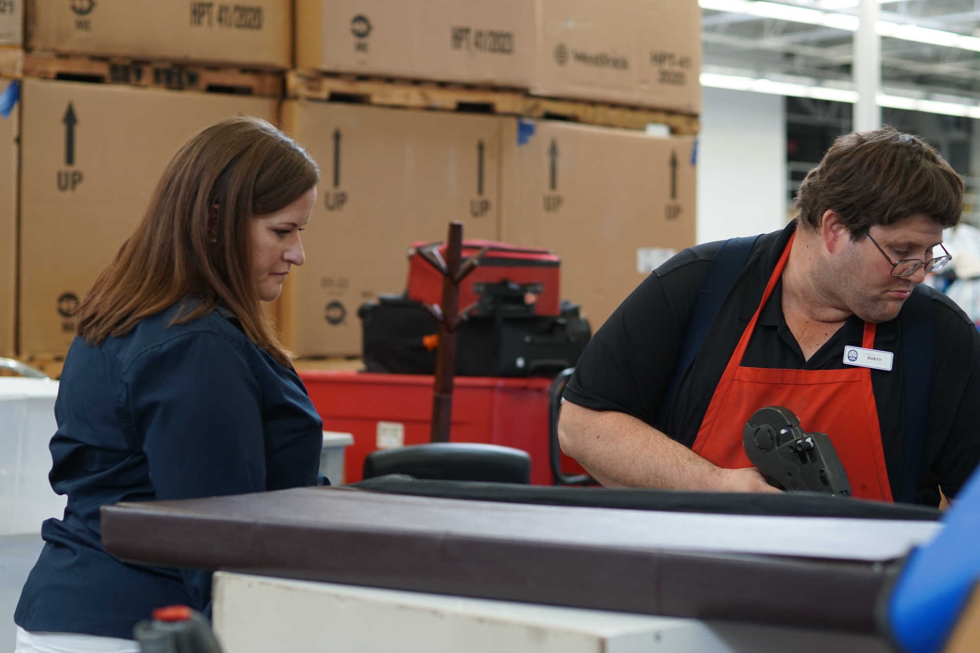 Two people work with furniture