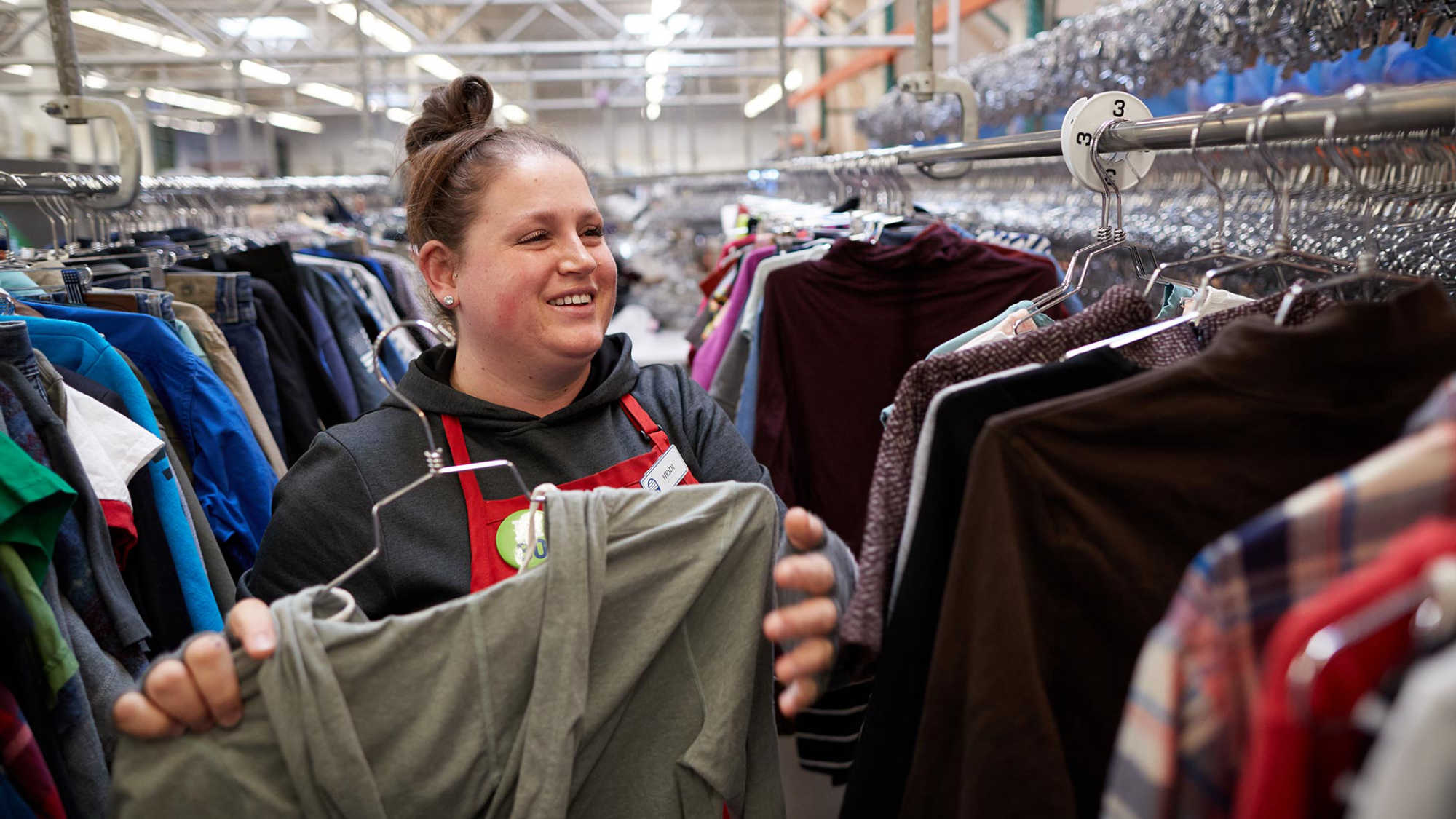 Associate Heidi sorting clothes at Deseret Industries